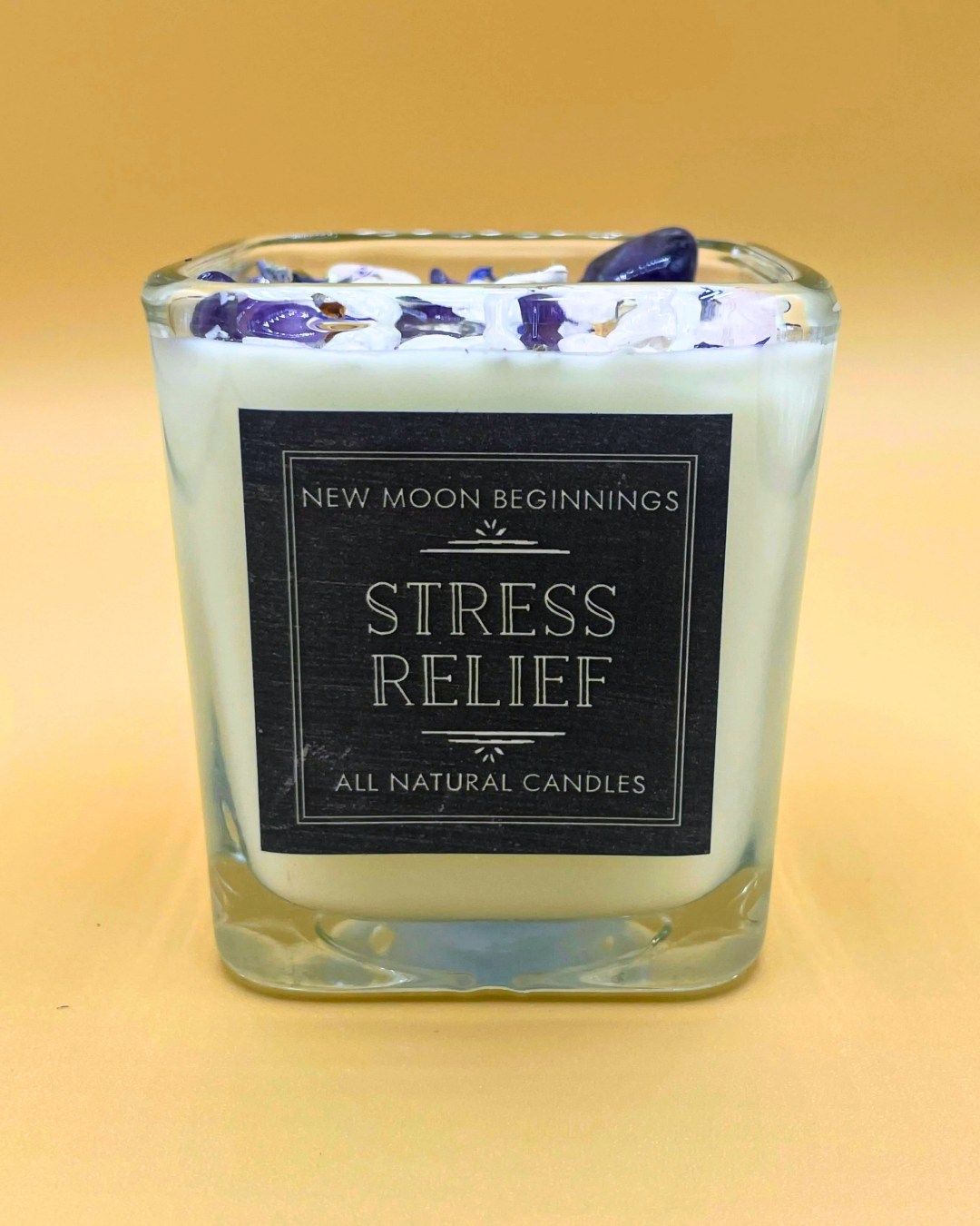 Candle with 'New Moon Beginnings' label on a gradient background