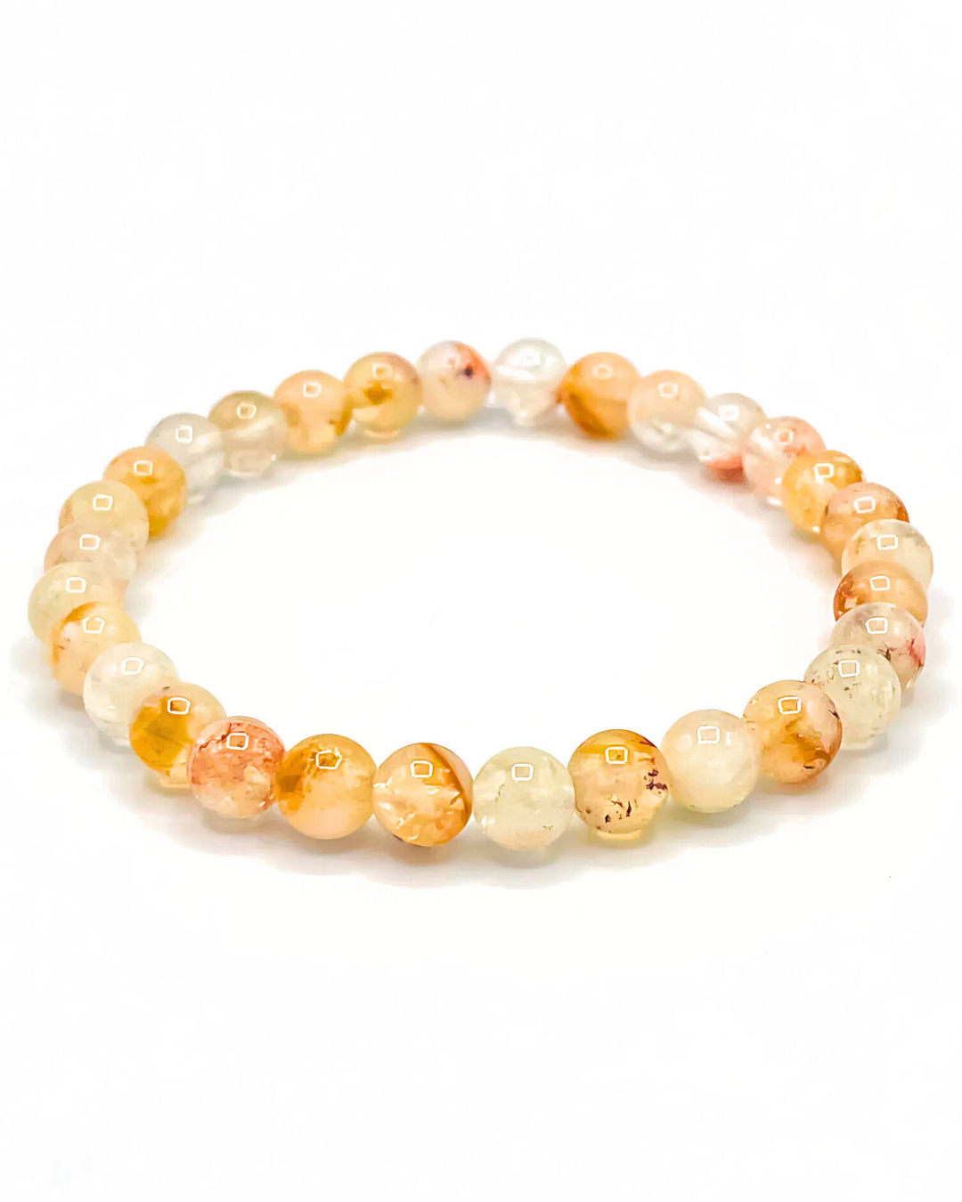 Beaded bracelet with orange and white beads on a white background