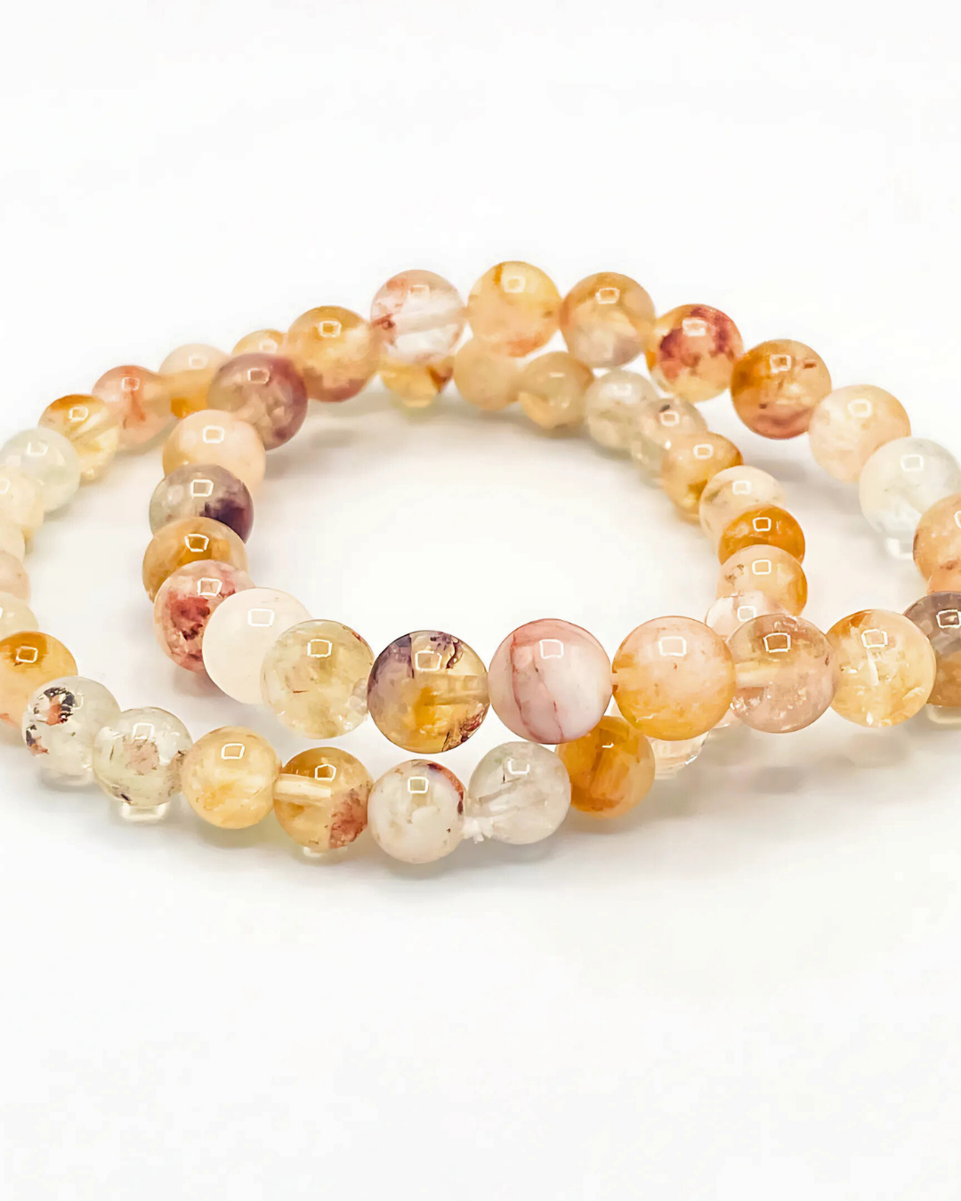 Set of two beaded bracelets with multicolored beads on a white background