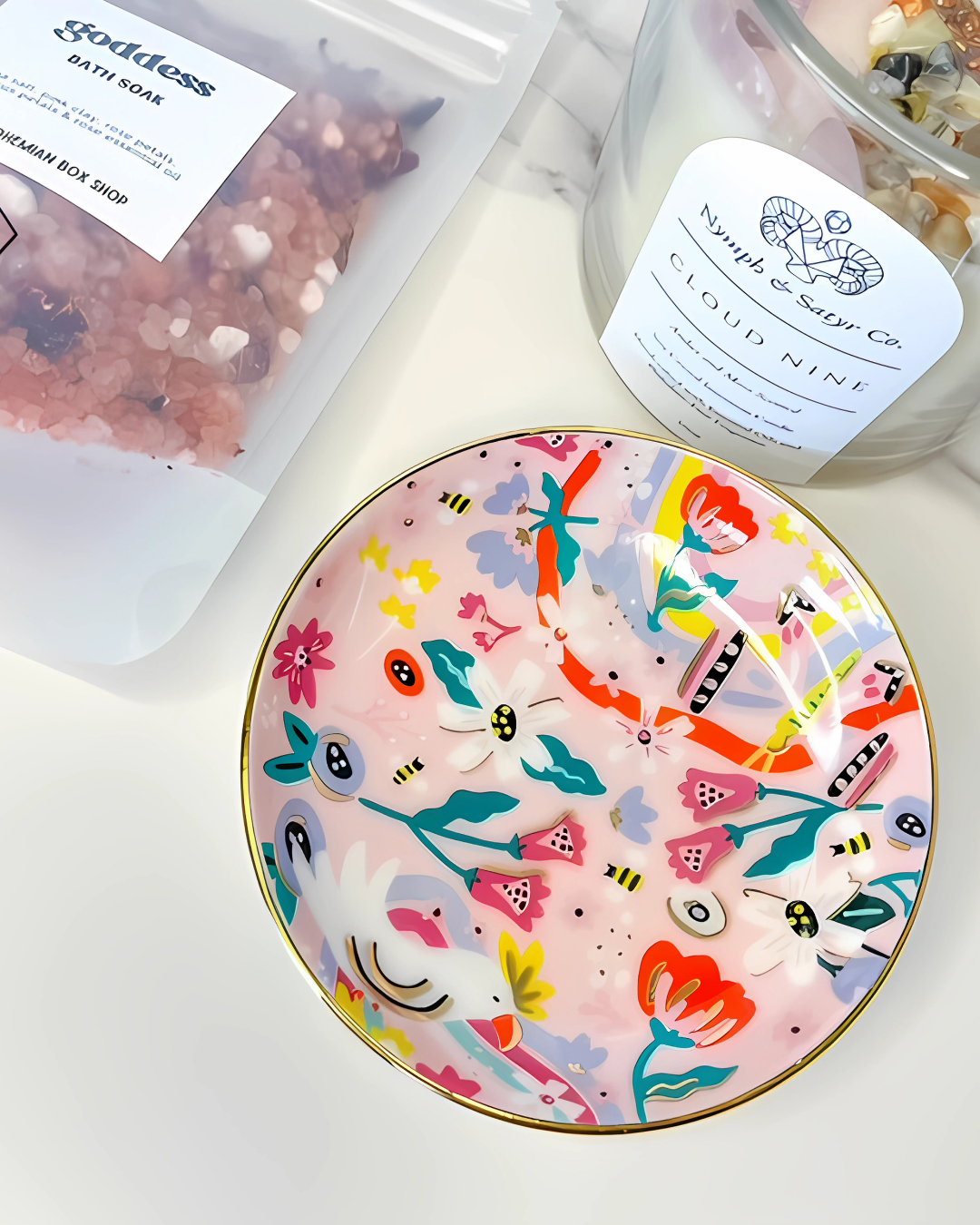 Colorful ceramic plate with animal and floral design on a white surface with bath products in the background.