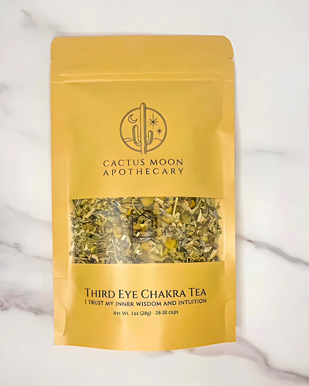 Yellow package of Third Eye Chakra Tea from Cactus Moon Apothecary on a marble background