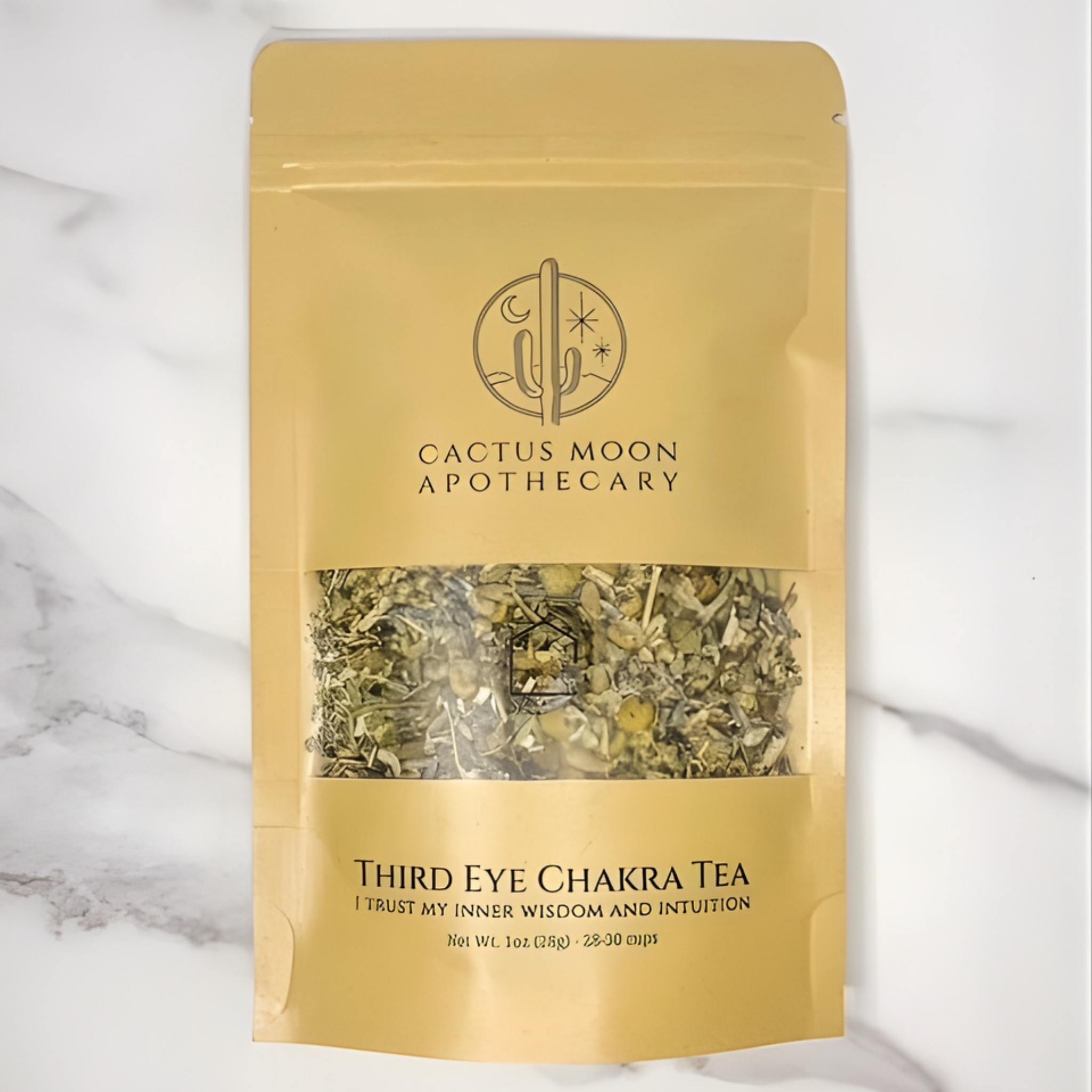 Gold packaging of Third Eye Chakra Tea from Cactus Moon Apothecary on a marble surface