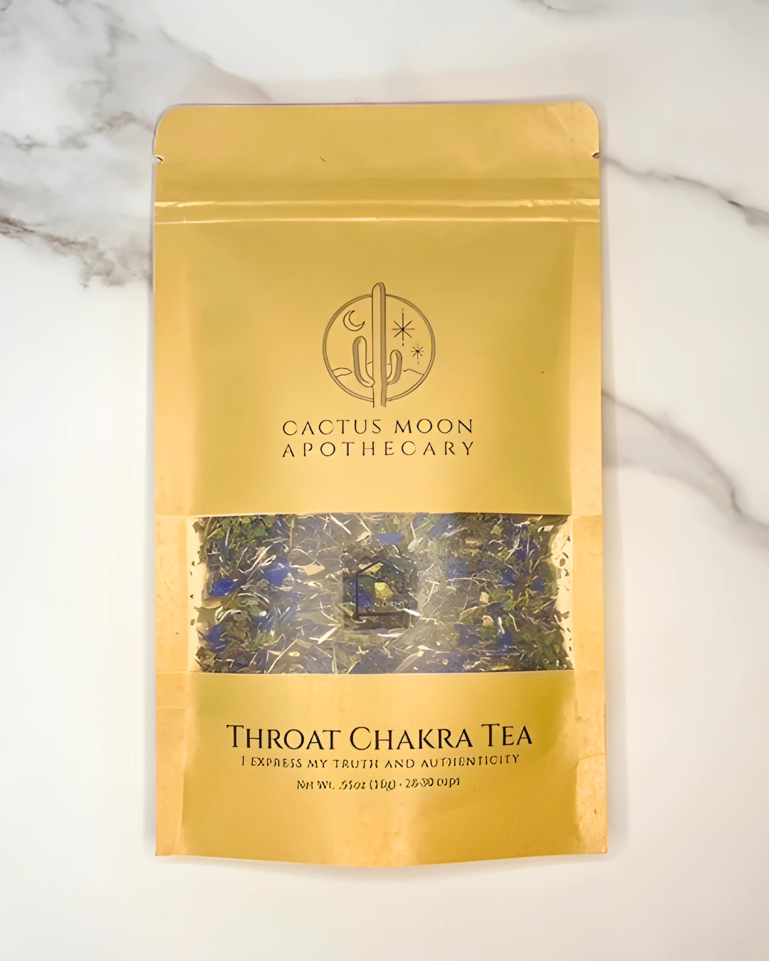 Gold package of Cactus Moon Apothecary Throat Chakra Tea on a marble background