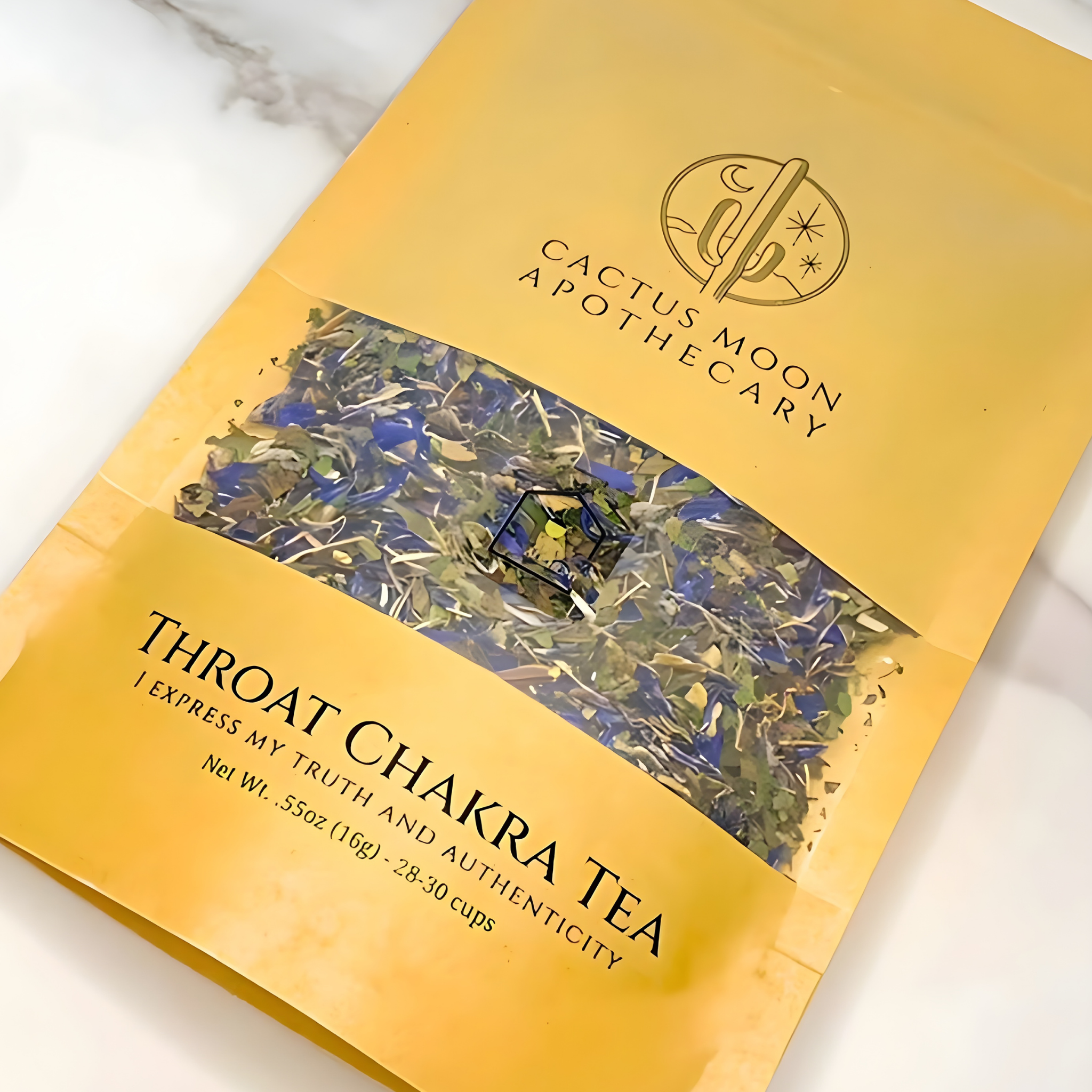 Yellow package of Cactus Moon Apothecary Throat Chakra Tea on a marble surface