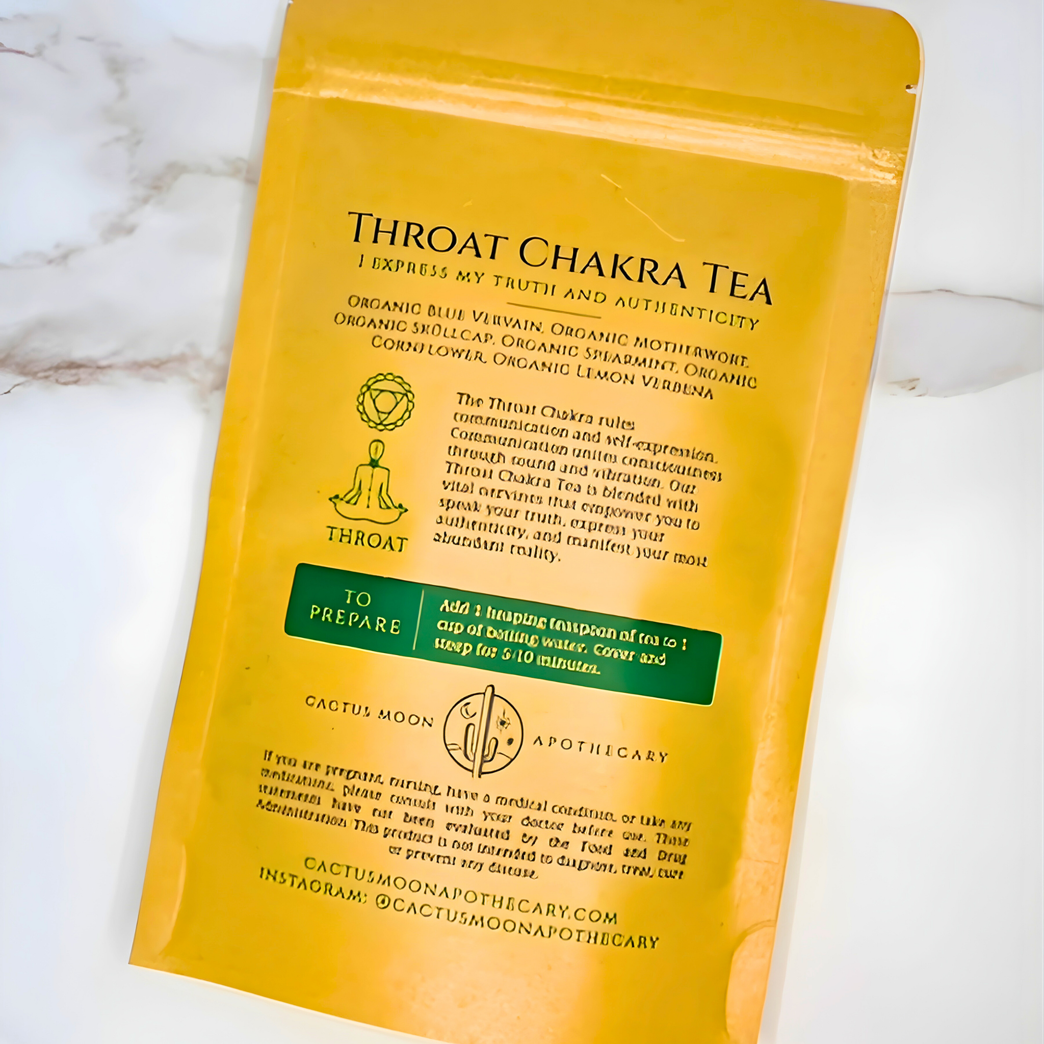 Yellow package of Throat Chakra Tea on a marble surface