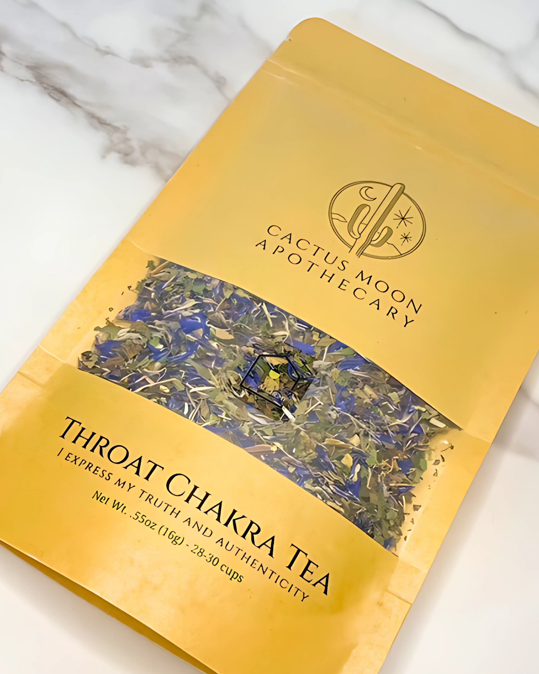 Yellow package of Throat Chakra Tea from Cactus Moon Apothecary on a marble surface