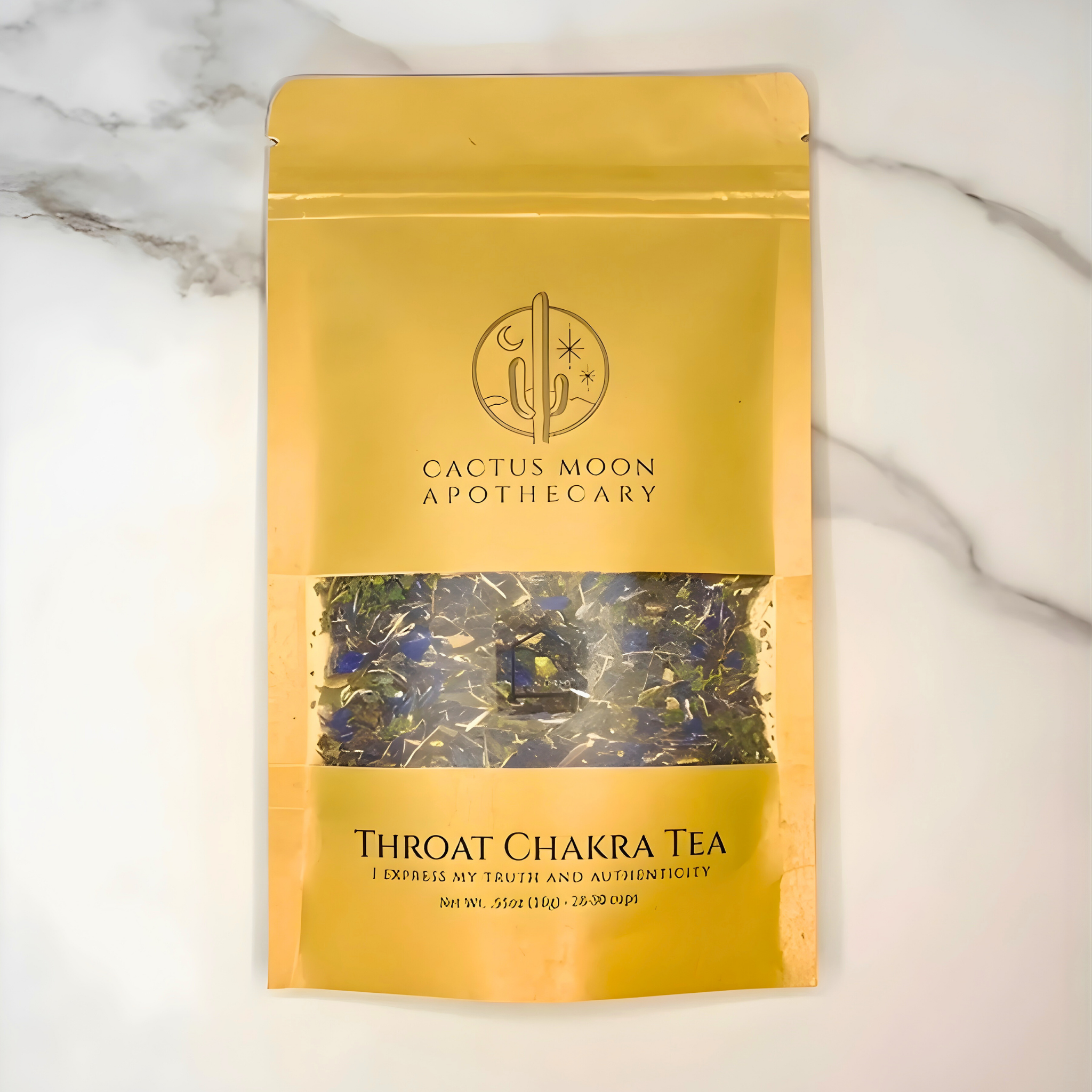 Yellow package of Throat Chakra Tea from Cactus Moon Apothecary on a marble background
