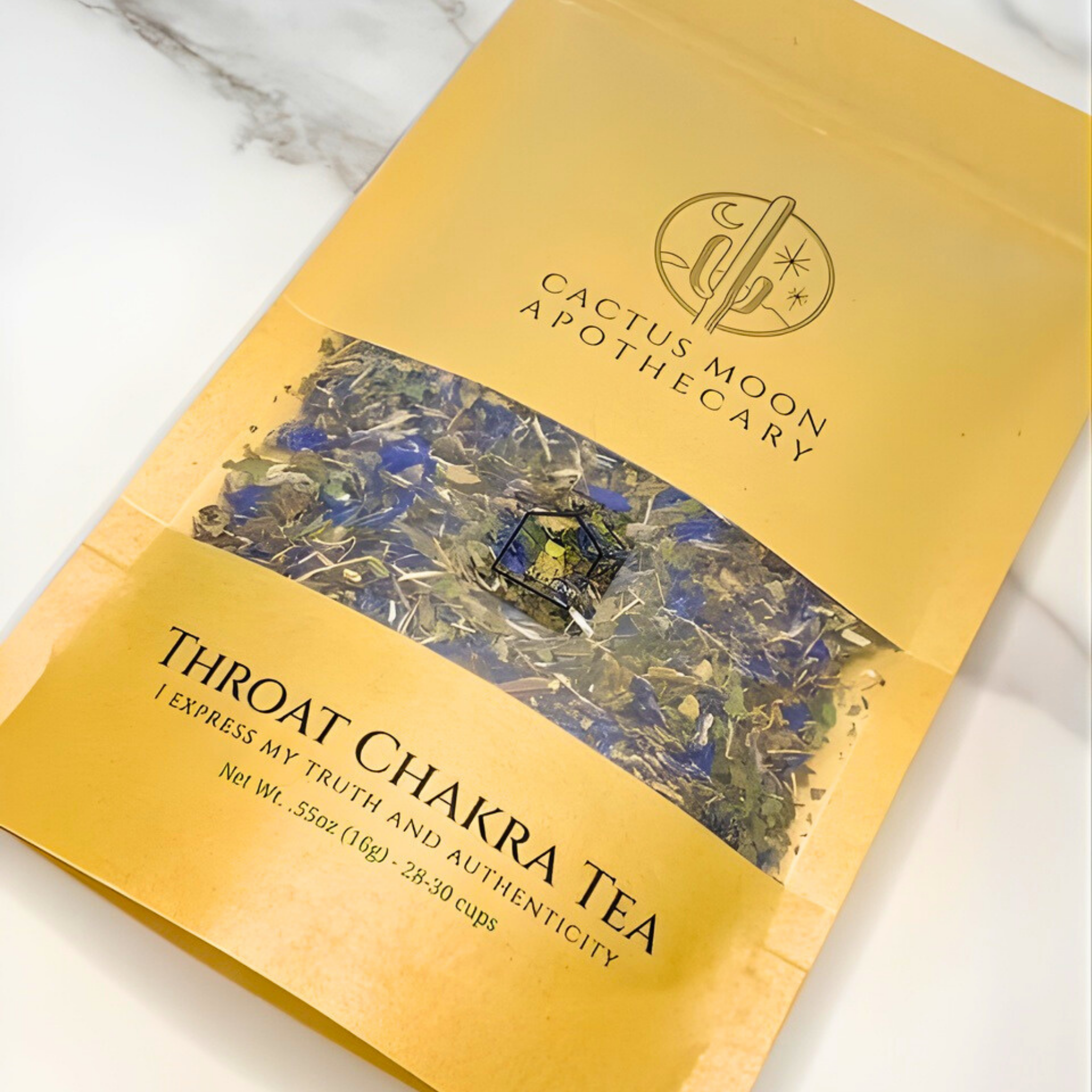 Yellow package of Throat Chakra Tea from Cactus Moon Apothecary on a marble surface