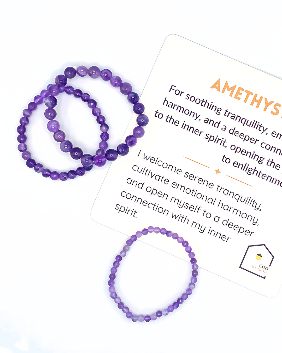 Purple beaded bracelets with a card explaining amethyst's properties on a white background