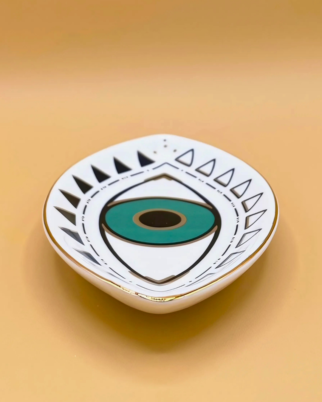 Enamel pin with eye design on a beige background