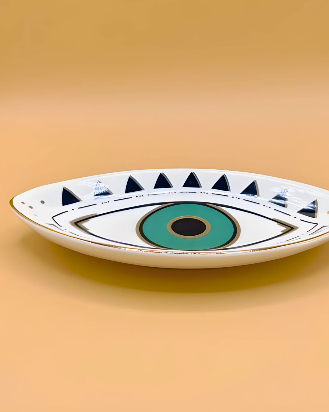 Ceramic plate with eye design on a beige background