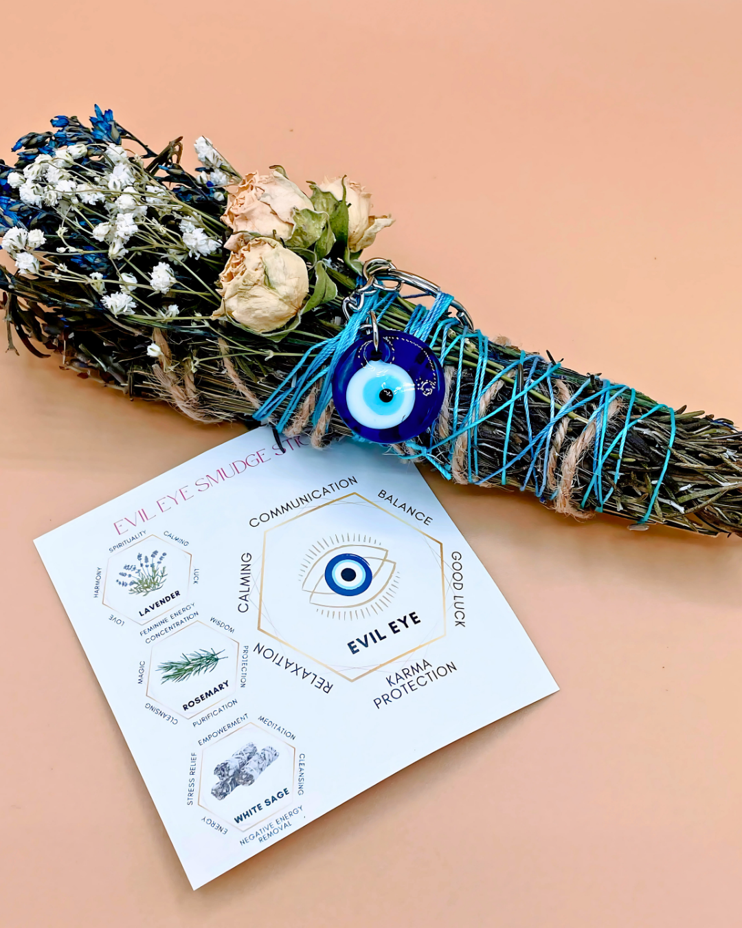 Smudge stick with dried herbs and flowers on a card with 'Evil Eye' design and text.