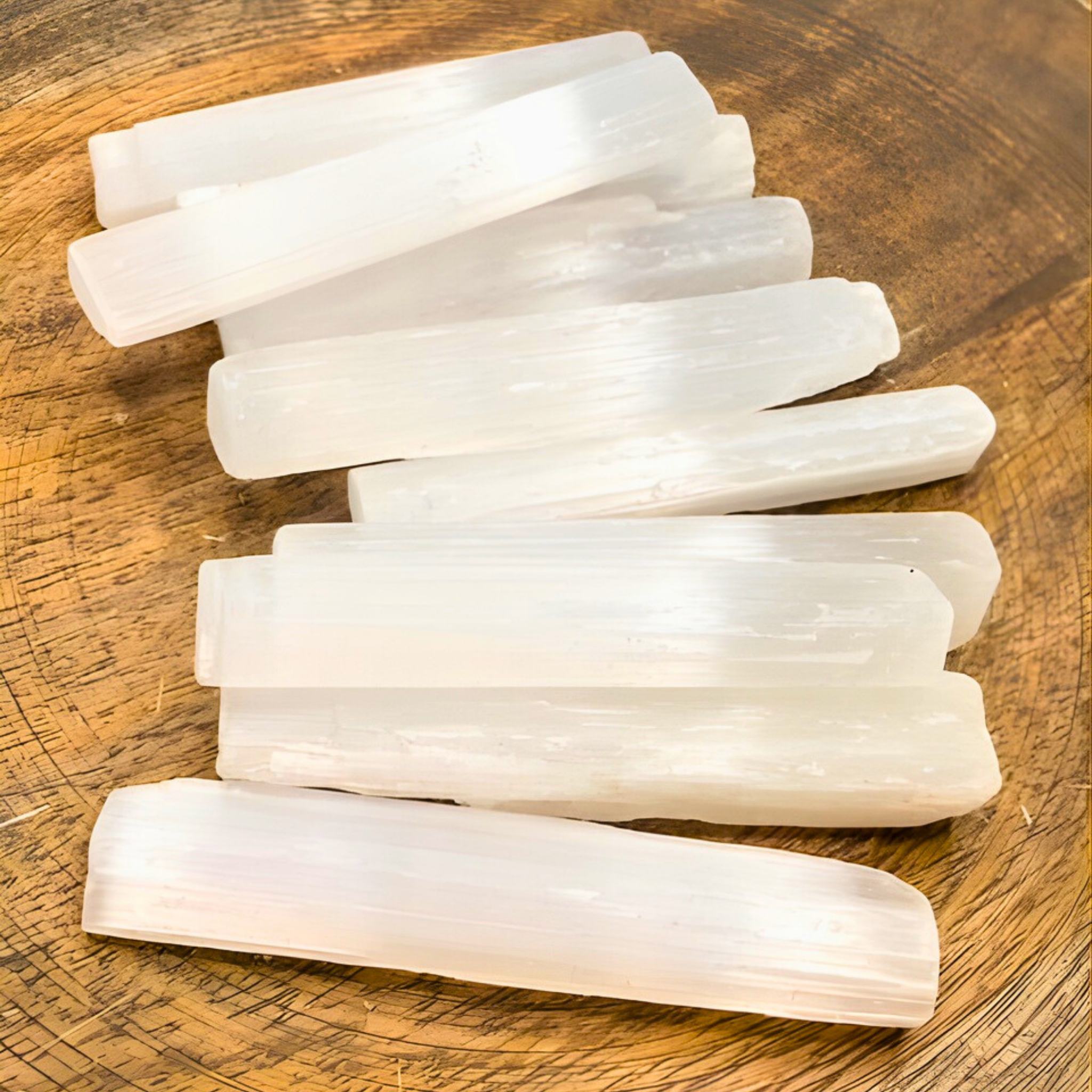 White crystal sticks on a wooden surface