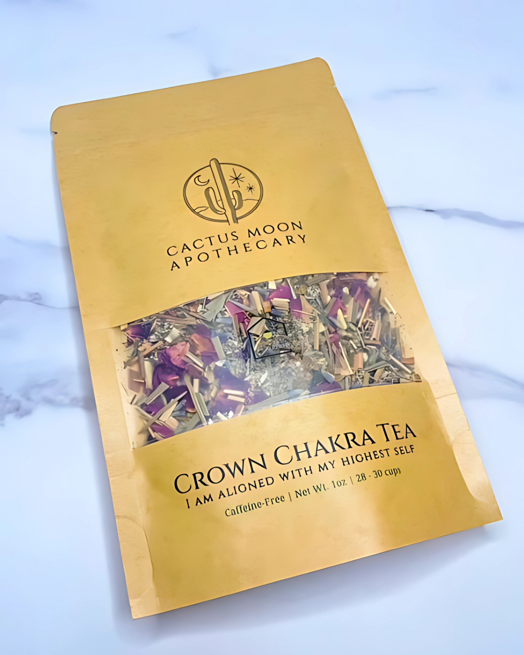 Gold package of Cactus Moon Apothecary Crown Chakra Tea on a light blue background